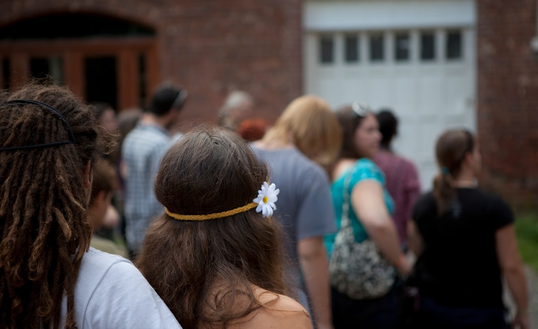 woman in white shirt with white flower on head