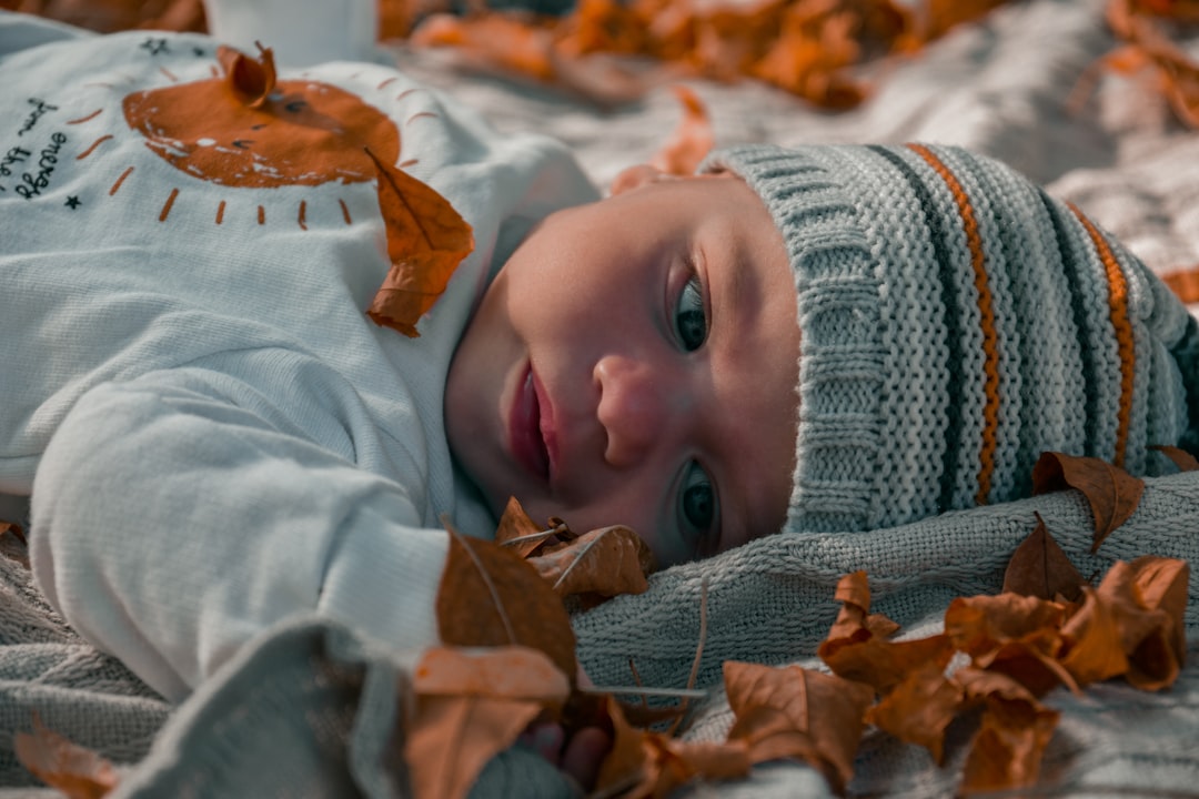 a baby lying on a blanket