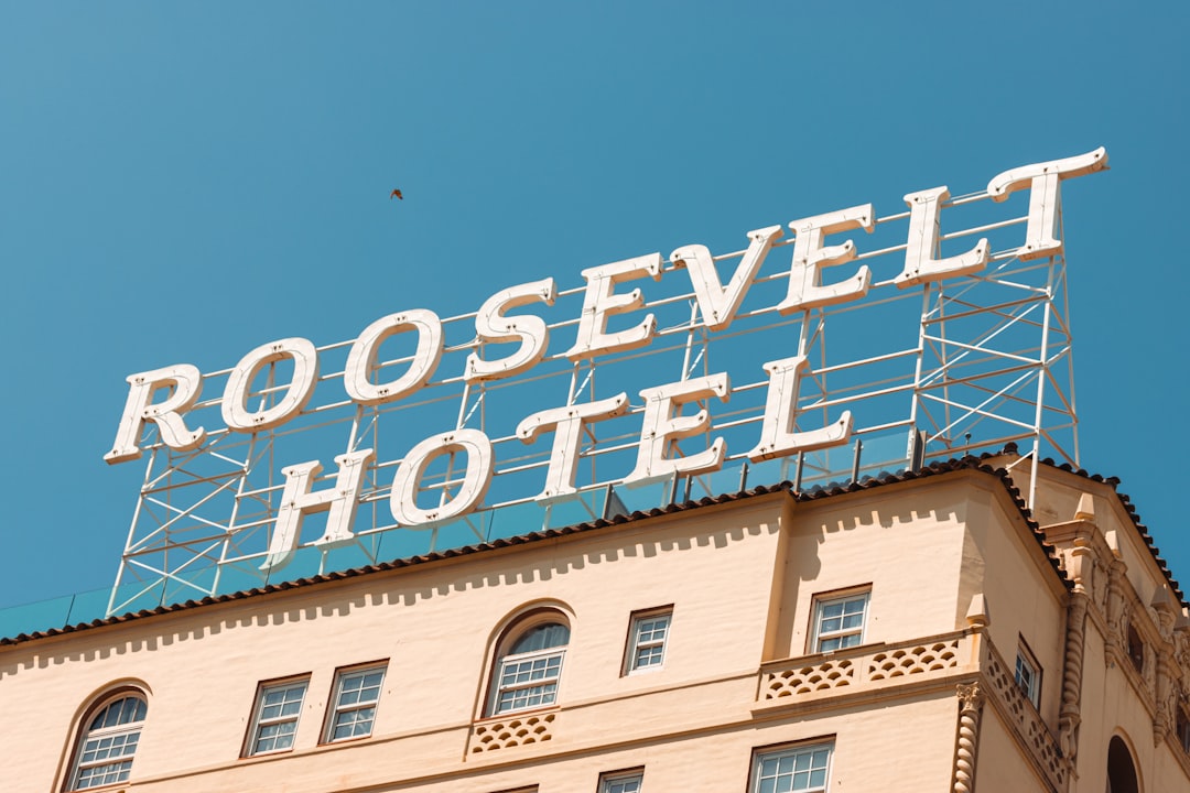 The roosevelt hotel sign against a clear blue sky.