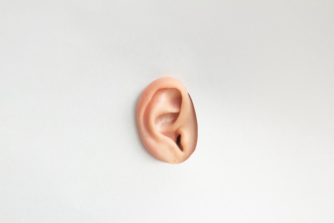 A single human ear isolated on a plain white background