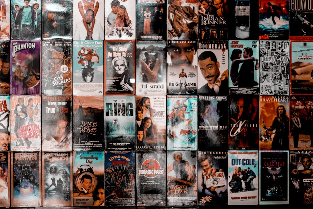 A wall covered with a grid of vintage VHS movie cassette covers