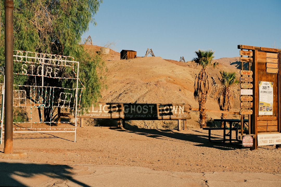 Entrance to a dusty desert ghost town with old buildings